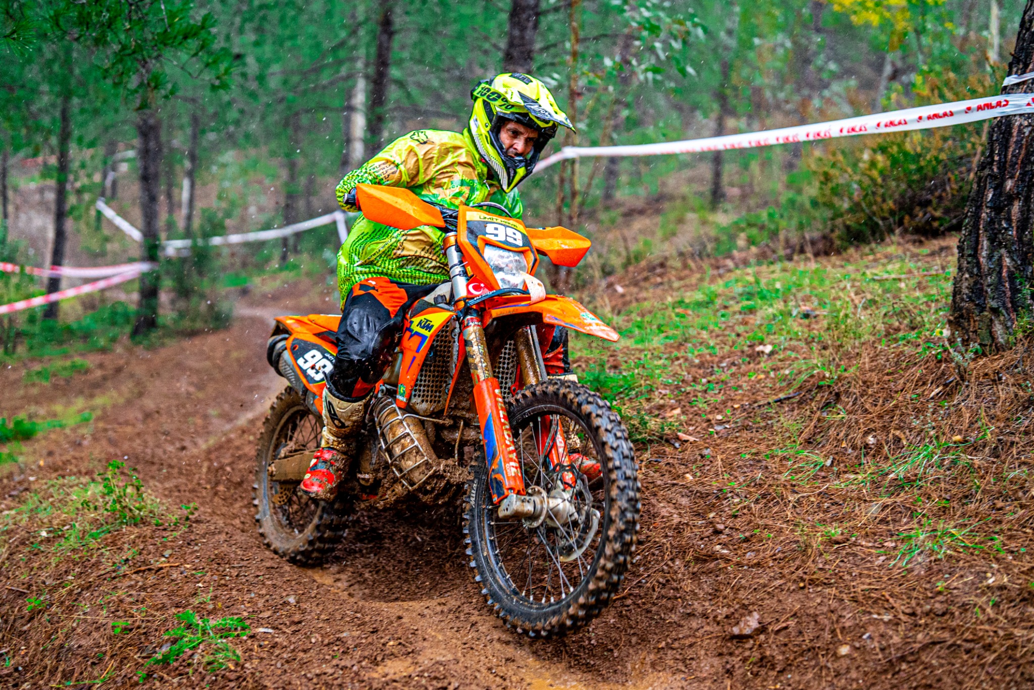 Number 99 enduro rider on a forest trail